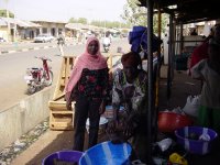 Phyllis and one of the women, showing how oil is squeezed out groundnut paste